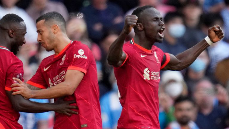 Liverpool&#39;s Sadio Mane, right, celebrates after scoring his side&#39;s third goal
