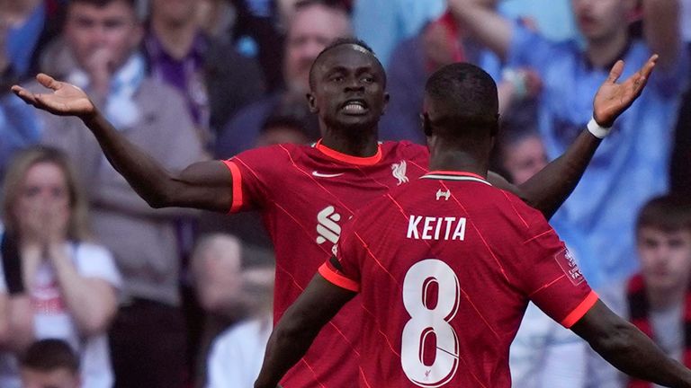 Liverpool&#39;s Sadio Mane, left, celebrates after scoring his side&#39;s second goal