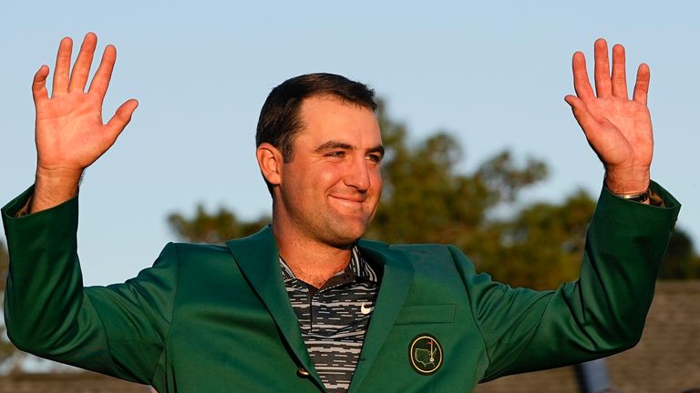 Scottie Scheffler celebrates after putting on the green jacket after winning the 86th Masters golf tournament on Sunday, April 10, 2022, in Augusta, Ga. (AP Photo/David J. Phillip)