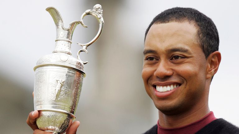 Tiger Woods of the United States holds the trophy after winning the British Open golf championship on the Old Course at St. Andrews, Scotland Sunday July 17, 2005. Woods finished the tournament at 14-under par to win the trophy.  (AP Photo/Alastair Grant)