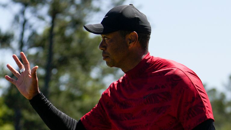 Tiger Woods waves to spectators on the 18th green after his final round at the Masters golf tournament on Sunday , April 10, 2022, in Augusta, Ga. (AP Photo/Jae C. Hong) 