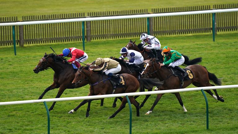 Tuscan (near side, in gold) battles past favourite Audience at Newmarket 