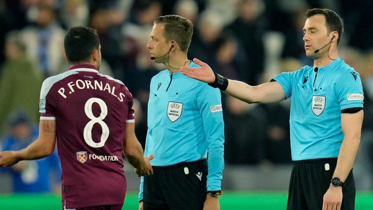 West Ham&#39;s Pablo Fornals argues with referees during the Europa League first-leg quarterfinal soccer match between West Ham United and Olympique Lyonnais at the London stadium in London Thursday, April 7, 2022. (AP Photo/Kirsty Wigglesworth)