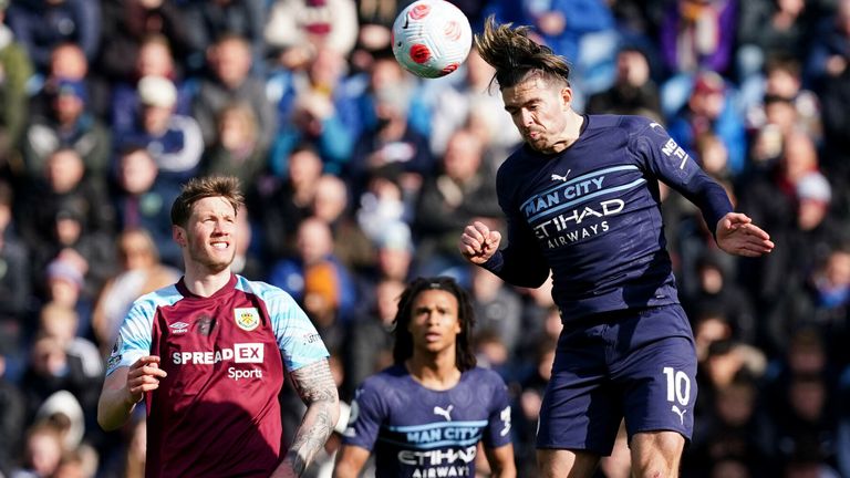 Manchester City's Jack Grealish (right) heads the ball under pressure from Burnley's Wout Weghorst (right) during the Premier League match at Turf Moor, Burnley. Picture date: Saturday April 2, 2022.
