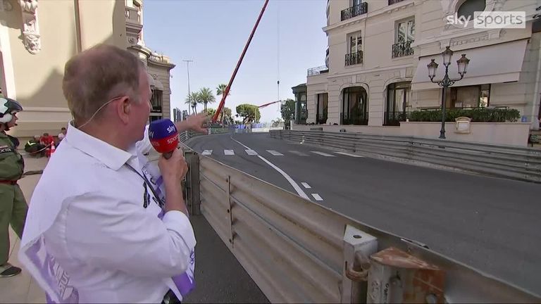 Martin Brundle assesses the cars as they pass through Casino Square in practice two for the Monaco Grand Prix