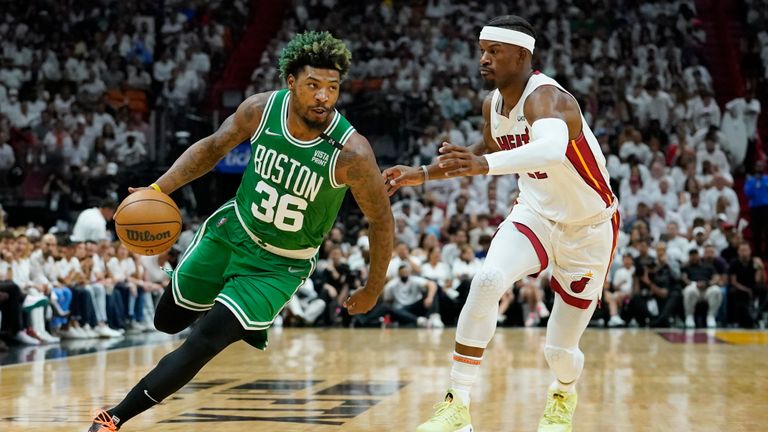 Boston Celtics guard Marcus Smart (36) dribbles around Miami Heat forward Jimmy Butler (22) during the first half of Game 2 of the NBA basketball Eastern Conference finals playoff series, Thursday, May 19, 2022, in Miami