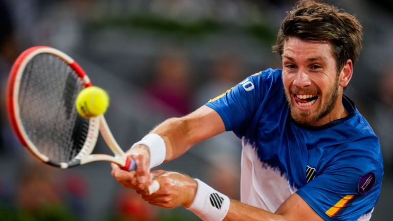 Cameron Norrie of Britain rerturns the ball against Spain's Carlos Alcaraz during their match at the Mutua Madrid Open tennis tournament in Madrid, Spain, Thursday, May 5, 2022. (AP Photo/Manu Fernandez)