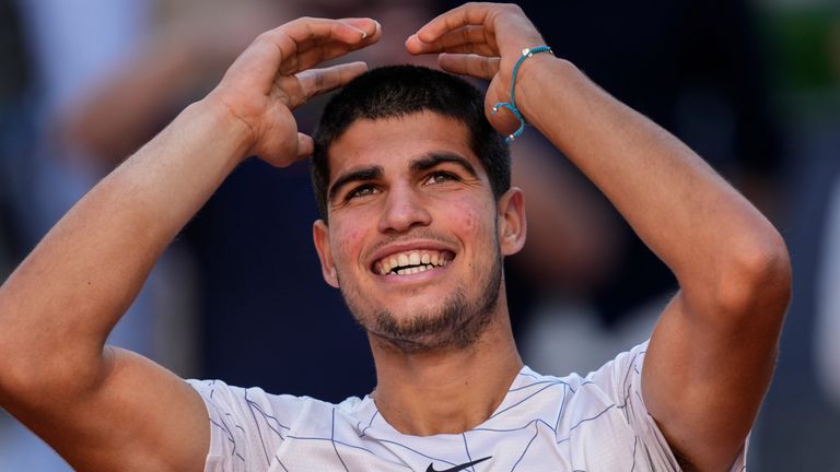 Spain&#39;s Carlos Alcaraz celebrates after winning a match against Spain&#39;s Rafael Nadal at the Mutua Madrid Open tennis tournament in Madrid, Friday, May 6, 2022. The French Open is scheduled to start Sunday on the red clay of Roland Garros on the outskirts of Paris.(AP Photo/Bernat Armangue, File)