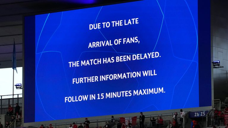 The screen announces a postponement of the Champions League final between Liverpool and Real Madrid, at the Stade de France