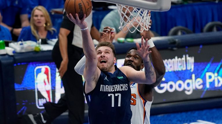 Dallas Mavericks guard Luka Doncic (77) drives to the basket past Phoenix Suns center Deandre Ayton, right, during the second half of Game 6 of an NBA basketball second-round playoff series, Thursday, May 12, 2022, in Dallas. (AP Photo/Tony Gutierrez)


