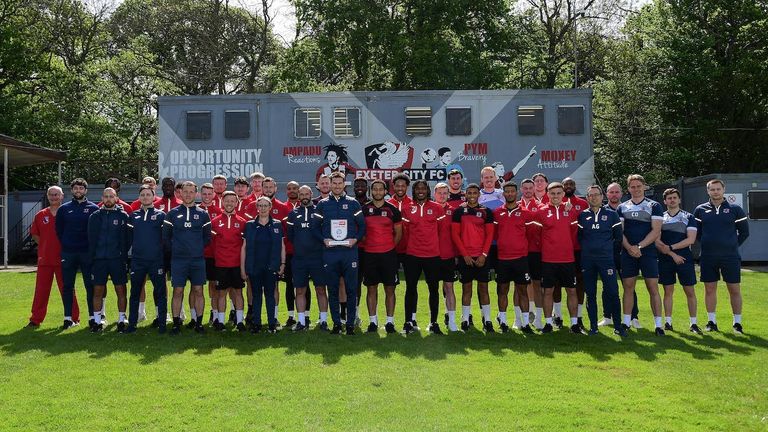 Sky Bet League 2 Manager of the Month for April - Matt Taylor, Manager of Exeter City poses with his trophy and his team and backroom staff during the Exeter City Training session ahead of the their title deciding fixture against Port Vale at Cliff Hill Training Ground, Exeter on 5 May 2022. Photo: Tom Sandberg/PPAUK