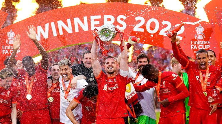 Jordan Henderson lifts the FA Cup trophy for Liverpool