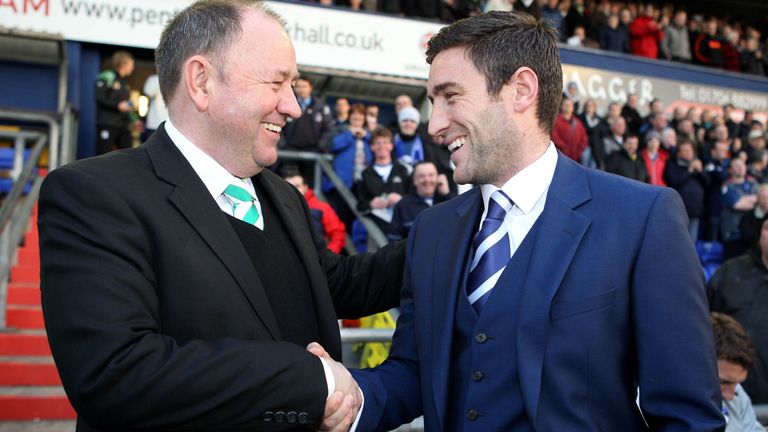 Johnson shakes hands with his dad, Gary Johnson, manager of Yeovil Town (left)