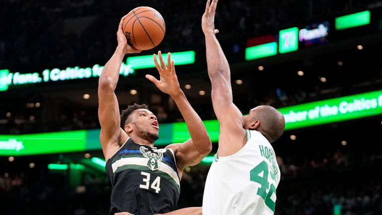 Milwaukee Bucks forward Giannis Antetokounmpo shoots at the basket as Boston Celtics center Al Horford defends during the first half of Game 7 of an NBA basketball Eastern Conference semifinals playoff series, Sunday, May 15, 2022, in Boston.