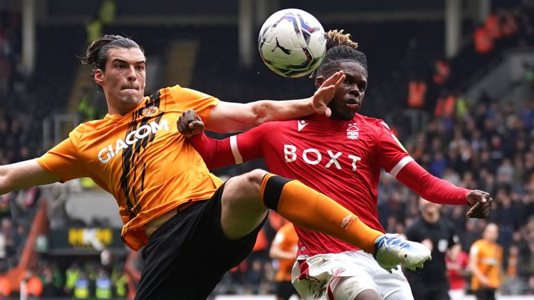 Jacob Greaves and Alex Mighten compete for the ball