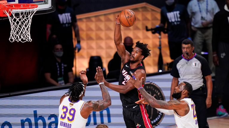 Miami Heat&#39;s Jimmy Butler passes the ball against Los Angeles Lakers&#39; Dwight Howard and LeBron James during Game 3 of the NBA Finals, Sunday, Oct. 4, 2020