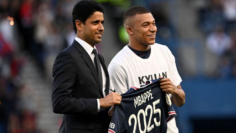 Kylian Mbappe poses with PSG president Nasser Al-Khelaifi after signing a new contract with the club