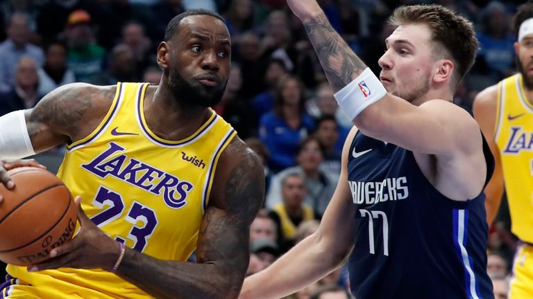 Los Angeles Lakers star LeBron James works against Dallas Mavericks guard Luka Doncic for a shot during a clash in November 2019
