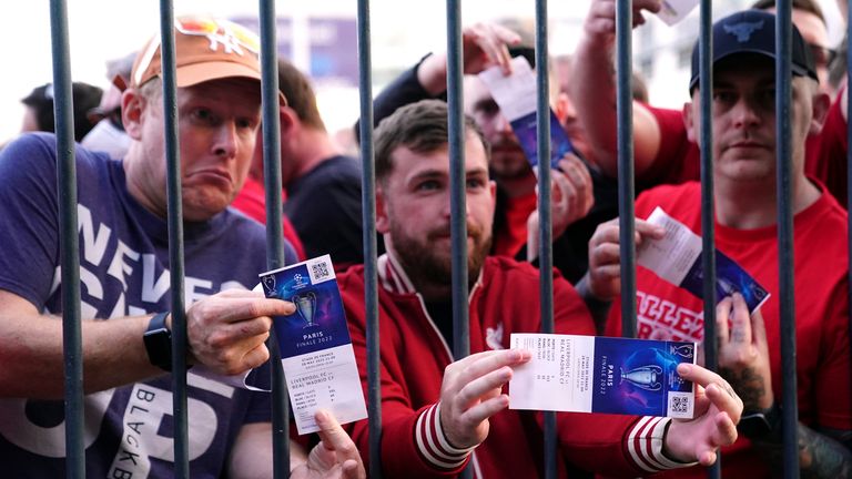 Liverpool supporters show their tickets as they struggle to get into the Champions League final