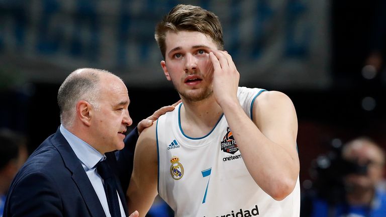 Luka Doncic receives words from his coach whilst in action for Real Madrid