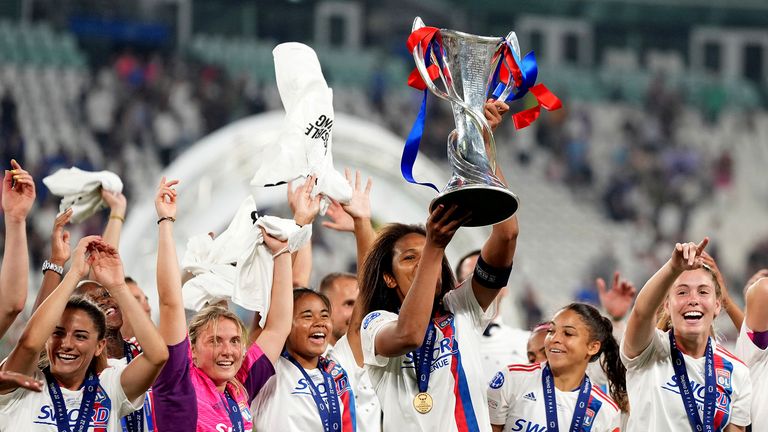 Olympique Lyon&#39;s Wendie Renard holds the trophy as the team celebrates winning the Women&#39;s Champions League final soccer match between Barcelona and Olympique Lyonnais