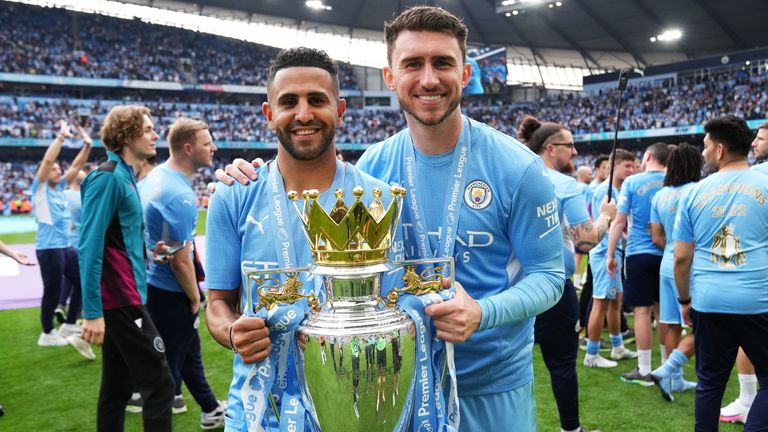 Aymeric Laporte and Riyad Mahrez with the Premier League trophy