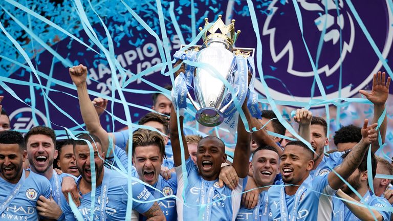 Manchester City's Fernandinho lifts the Premier League trophy aloft