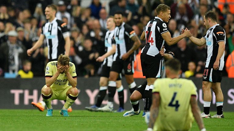 Arsenal players look dejected after the defeat to Newcastle