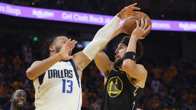 Golden State Warriors guard Klay Thompson, right, shoots against Dallas Mavericks guard Jalen Brunson (13) during the second half of Game 1 of the NBA basketball playoffs Western Conference finals in San Francisco.