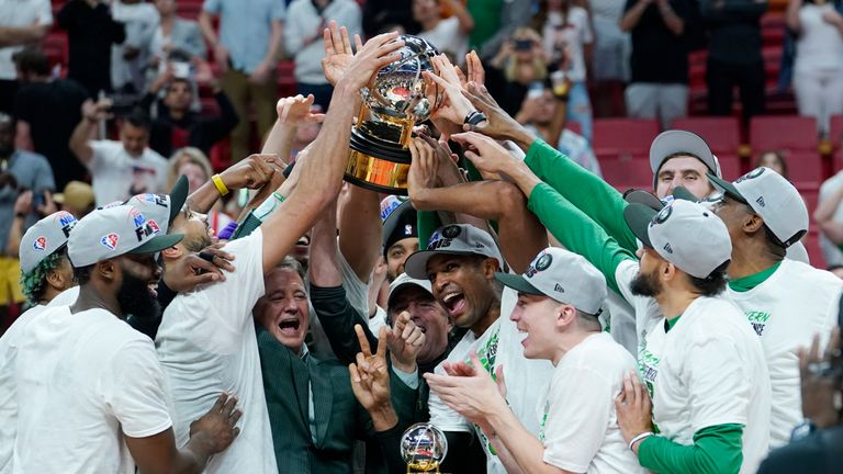 The Boston Celtics players raise the Eastern Conference trophy after defeating the Miami Heat in Game 7 of the NBA basketball Eastern Conference finals playoff series, Sunday, May 29, 2022, in Miami. 