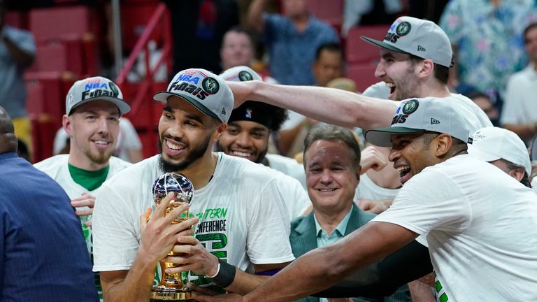 Boston Celtics forward Jayson Tatum is congratulated by his teammates for winning the NBA Eastern Conference MVP trophy after defeating the Miami Heat in Game 7 of the NBA basketball Eastern Conference finals playoff series, Sunday, May 29, 2022, in Miami.
