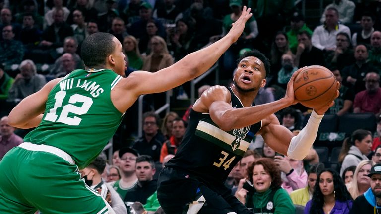 Milwaukee Bucks forward Giannis Antetokounmpo, right, is pressured by Boston Celtics forward Grant Williams (12) while lining up a shot in the first half of Game 2 of an NBA basketball Eastern Conference semifinal series Tuesday, May 3, 2022, in Boston