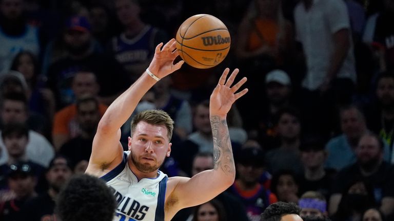 Dallas Mavericks guard Luka Doncic passes against the Phoenix Suns during the first half of Game 7 of an NBA basketball Western Conference playoff semifinal, Sunday, May 15, 2022, in Phoenix.