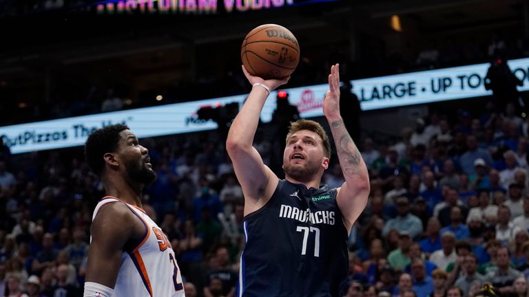 Dallas Mavericks guard Luka Doncic (77) shoots over Phoenix Suns center Deandre Ayton, left, during the second half of Game 6 of an NBA basketball second-round playoff series, Thursday, May 12, 2022, in Dallas. (AP Photo/Tony Gutierrez)


