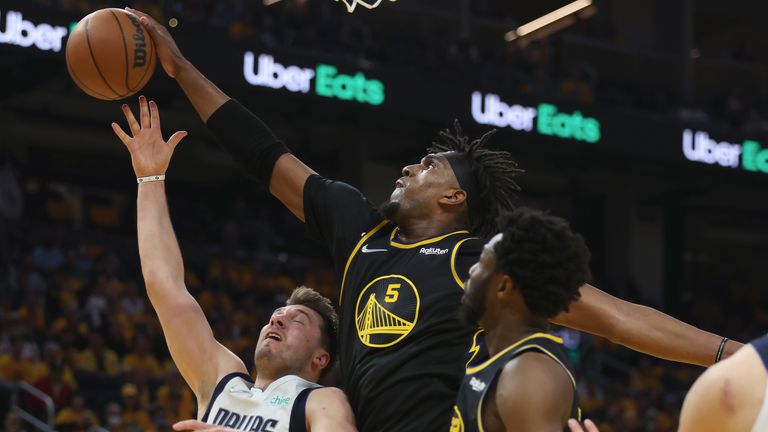 Golden State Warriors centre Kevon Looney (5) defends against a shot by Dallas Mavericks guard Luka Doncic during the first half of Game 1 of the NBA basketball playoffs Western Conference finals in San Francisco, Wednesday, May 18, 2022.