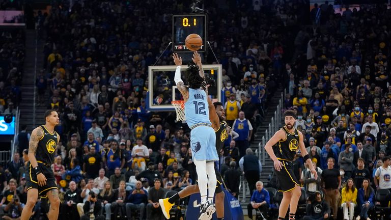Memphis Grizzlies guard Ja Morant (12) makes a 3-point basket at the buzzer during the first half of Game 3 of the team&#39;s NBA basketball Western Conference playoff semifinal against the Golden State Warriors in San Francisco, Saturday, May 7, 2022.