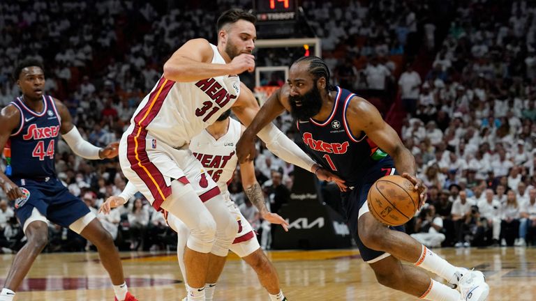 Philadelphia 76ers guard James Harden (1) drives to the basket as Miami Heat guard Max Strus (31) defends, during the first half of Game 1 of an NBA basketball second-round playoff series, Monday, May 2, 2022, in Miami.