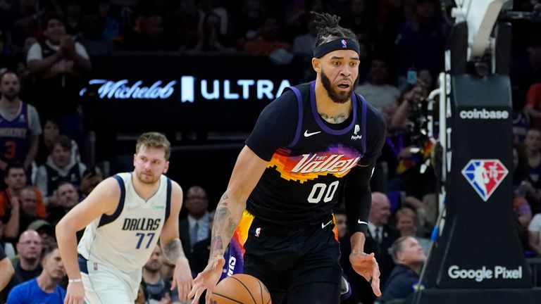 Phoenix Suns center JaVale McGee (00) drives up court past Dallas Mavericks guard Luka Doncic (77) during the second half of Game 1 in the second round of the NBA Western Conference playoff series Monday, May 2, 2022, in Phoenix.