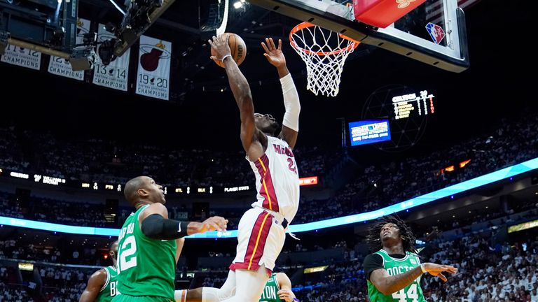 Miami Heat forward Jimmy Butler (22) drives to the basket during the first half of Game 7 of the NBA basketball Eastern Conference finals playoff series against the Boston Celtics, Sunday, May 29, 2022, in Miami. 