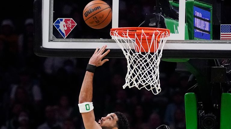 Boston Celtics forward Jayson Tatum, center, shoots against Miami Heat forward Caleb Martin (16) during the first half of Game 4 of the NBA basketball playoffs Eastern Conference finals, Monday, May 23, 2022, in Boston. 