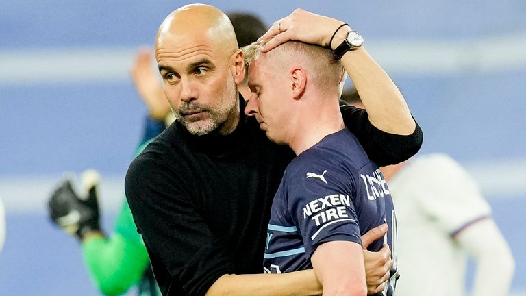 Josep Guardiola consoles Oleksandr Zinchenko after Manchester City's defeat by Real Madrid.