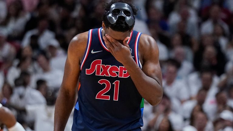 Philadelphia 76ers center Joel Embiid wipes his face during the second half of Game 5
