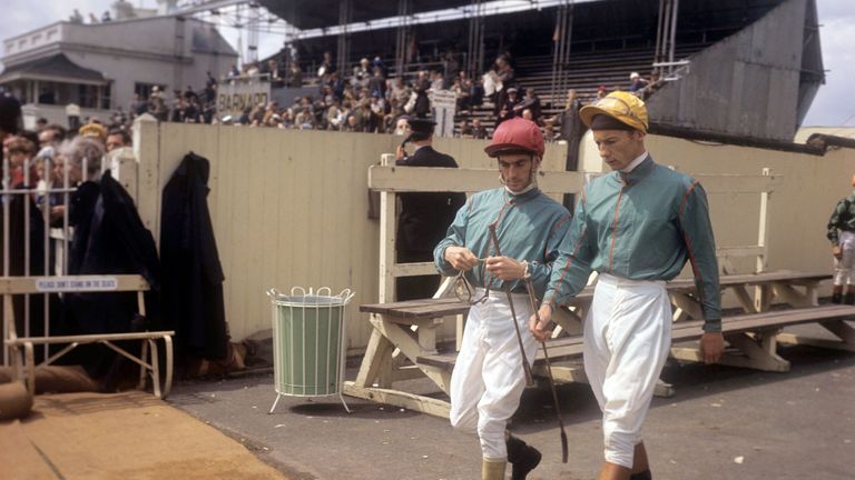 Piggott (yellow cap) heads out to ride at Epsom