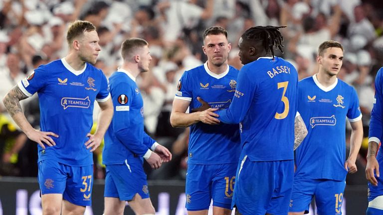 Rangers players console Aaron Ramsey after his penalty miss