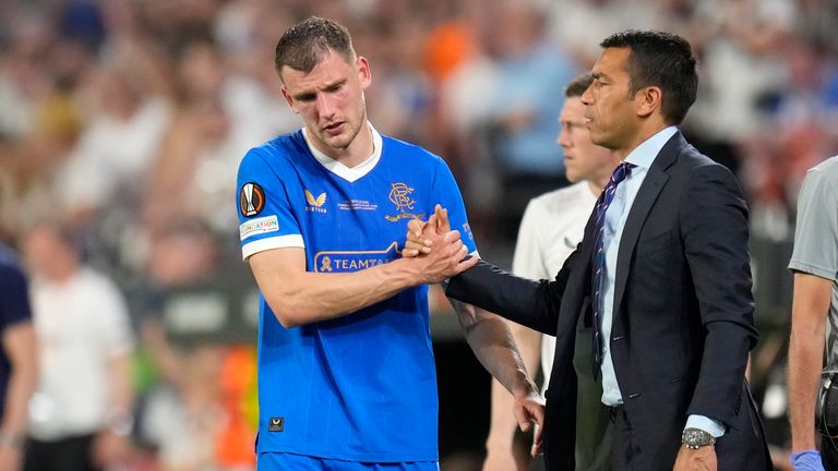 Rangers' Borna Barisic shakes hands with Rangers' head coach Giovanni van Bronckhorst after being substituted during the Europa League final soccer match between Eintracht Frankfurt and Rangers FC at the Ramon Sanchez Pizjuan stadium in Seville, Spain, Wednesday, May 18, 2022. 