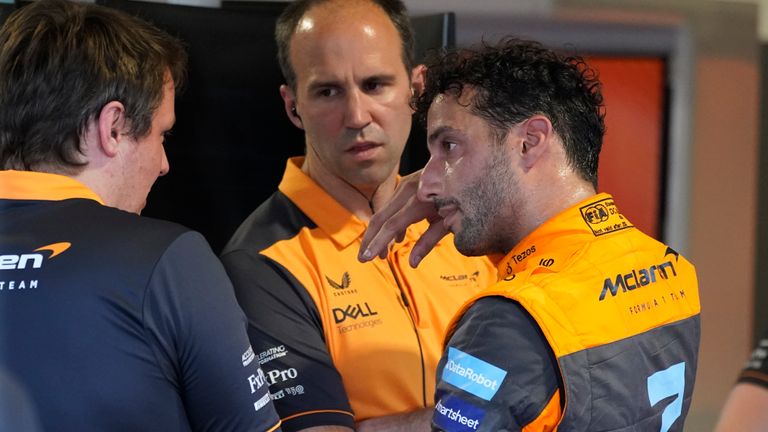McLaren driver Daniel Ricciardo of Australia speaks to crew members.