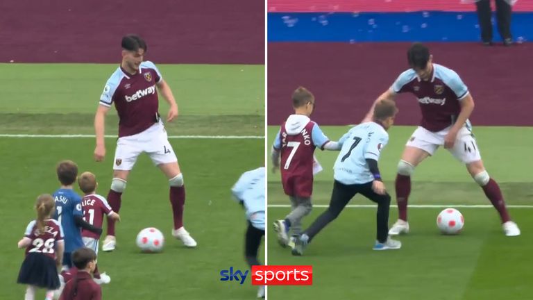 Declan Rice plays football with kids on the West Ham pitch following their draw with Manchester City