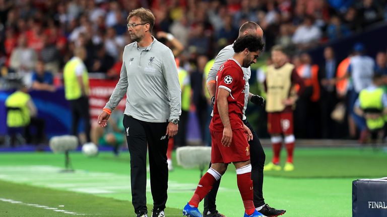 Liverpool&#39;s Mohamed Salah (right) walks off the pitch after picking up an injury during the 2018 Champions League Final 