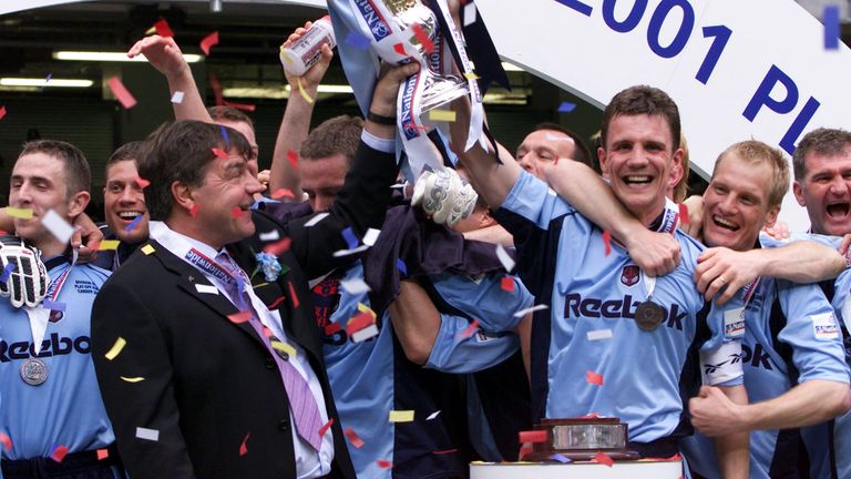 Bolton Wanderers captain Gudni Bergsson and manager Sam Allardyce (centre, left) lift the trophy, after the Nationwide Division One play-off final against Preston at the Millennium Stadium, Cardiff. Bolton are promoted to the FA Premiership after defeating Preston 3-0.