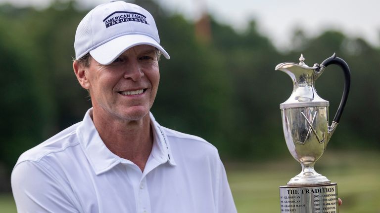 Steve Stricker poses with the trophy on the 18th hole after winning the the Regions Tradition, a PGA Tour Champions golf event, Sunday, May 15, 2022, in Birmingham, Ala. (AP Photo/Vasha Hunt)